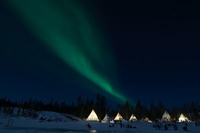 Scenic view of snowcapped mountains against sky at night