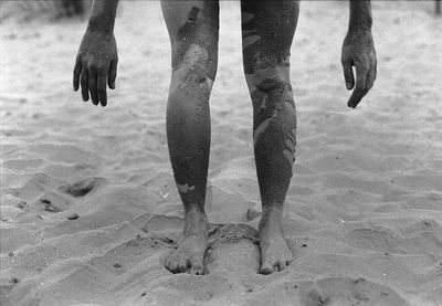 Low section of woman standing on beach