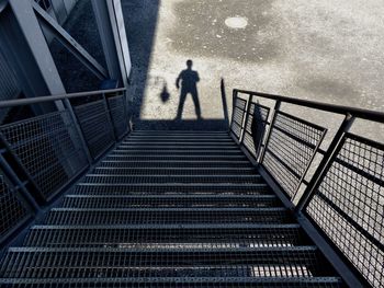 High angle view of silhouette man standing on staircase