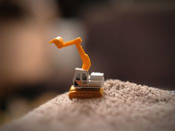 Close-up of toy construction vehicle on rug