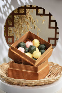 Three color kkultteok is ball shaped rice cake filled with honey and sesame syrup, 