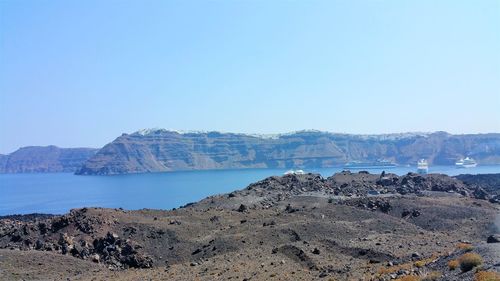Panoramic view of sea and mountains against clear sky