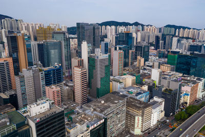 High angle view of modern buildings in city against sky