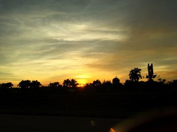 Silhouette trees against sky during sunset