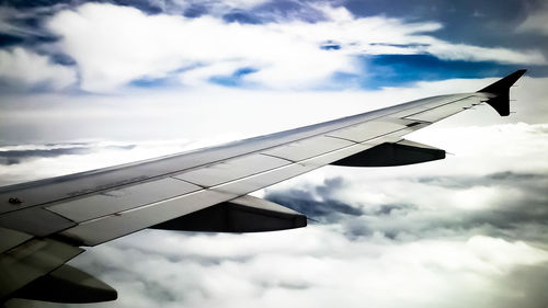 Low angle view of airplane flying against sky