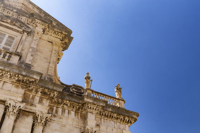 Low angle view of historical building against blue sky