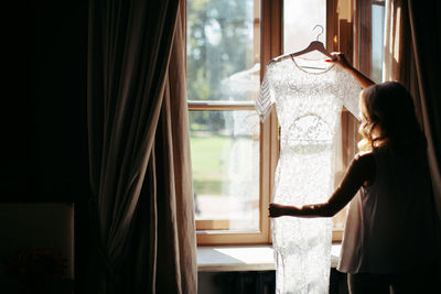 Woman looking through window