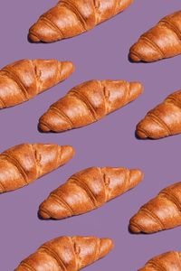 Croissant arranged on purple background
