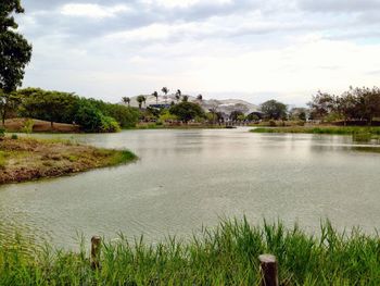 Scenic view of grassy field against cloudy sky