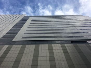 Low angle view of building against cloudy sky