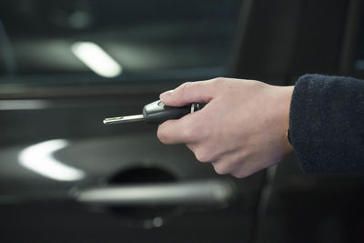 Close-up of hand holding cigarette