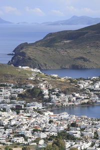 High angle view of townscape by sea against sky