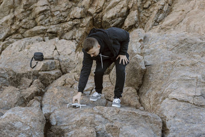 Rear view of man standing on rock