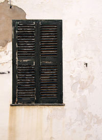 Low angle view of window on wall