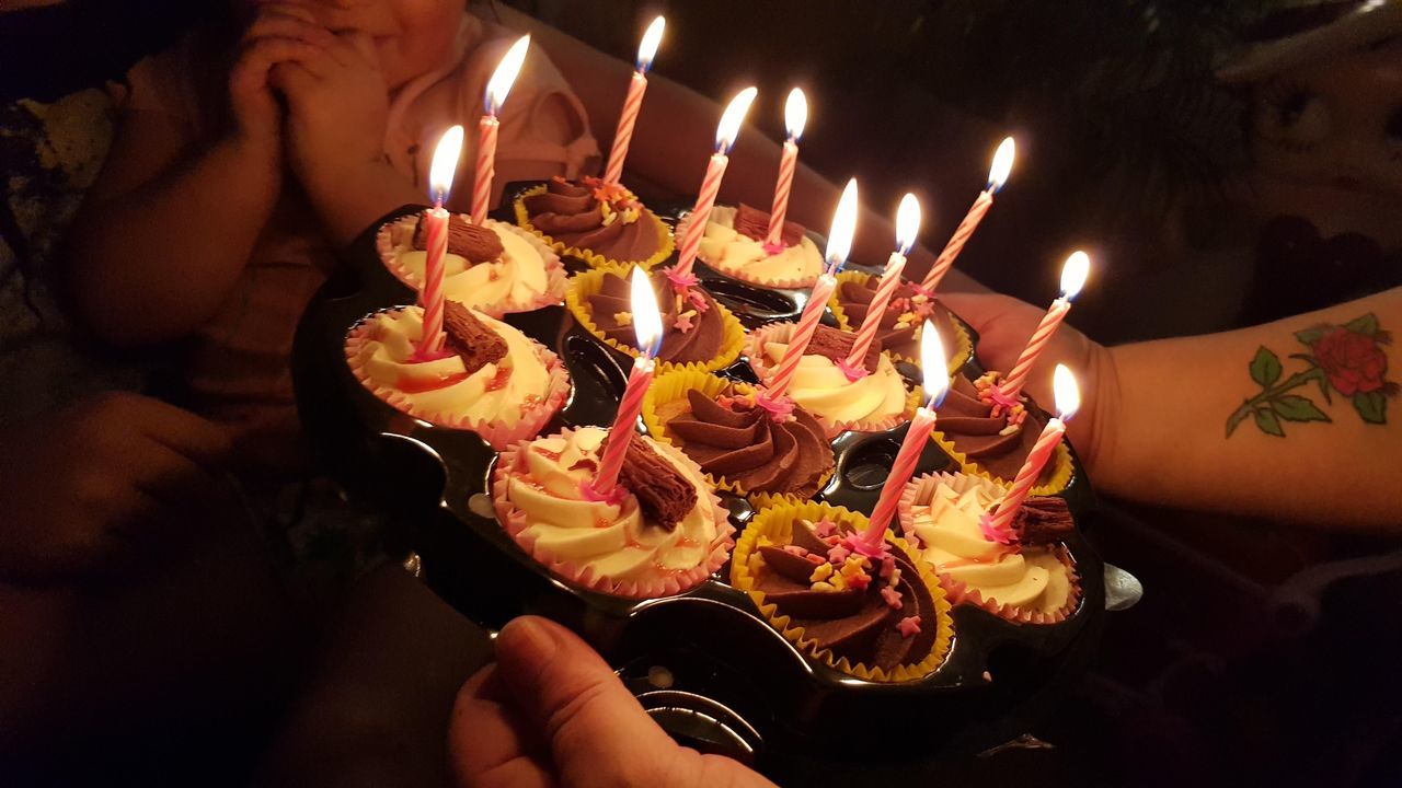 LOW ANGLE VIEW OF PEOPLE WITH CAKE