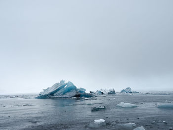 Scenic view of frozen sea against sky