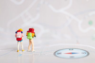 Miniature people backpackers walking with friends 