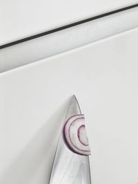 High angle view of onion slice on knife
