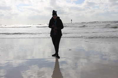 Rear view of man standing on beach