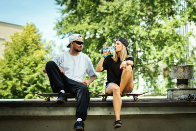 Couple sitting at skateboard park