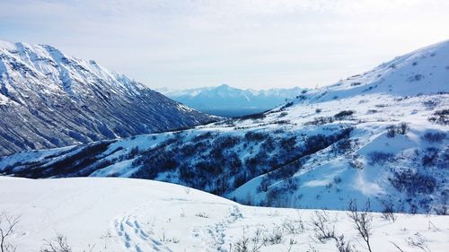 Scenic view of snowcapped mountains against sky