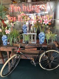 View of potted plants on bicycle sign