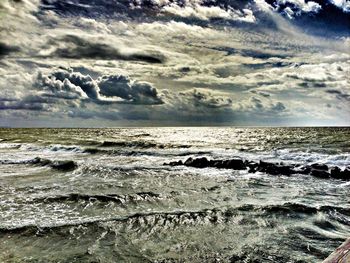 Scenic view of sea against cloudy sky