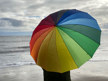 Woman under an umbrella at the beach
