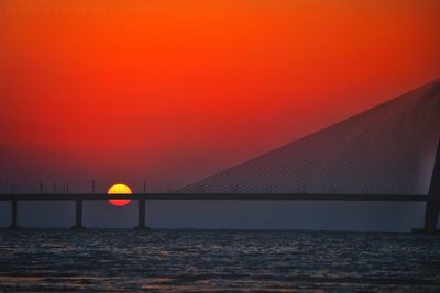 View of bridge over sea during sunset