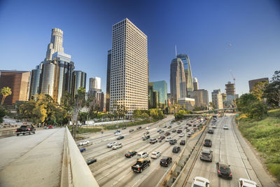 Panoramic view of city street and buildings against sky