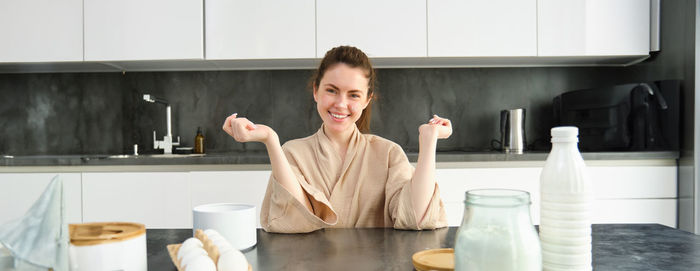 Portrait of young woman sitting at home