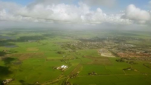 Aerial view of agricultural field against sky