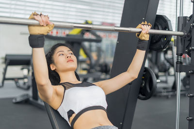 Young woman exercising at gym