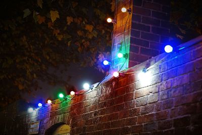 Low angle view of illuminated street light at night