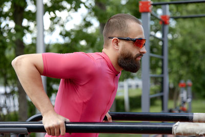 Side view of man exercising in gym