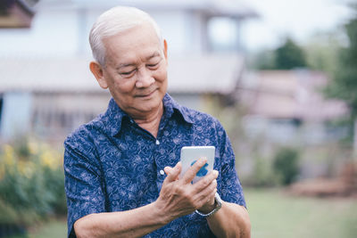 Mid adult man using mobile phone