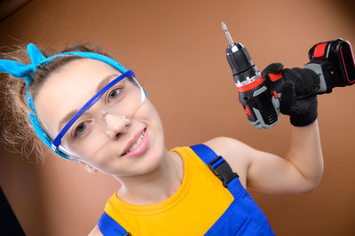Close-up of young woman holding headphones