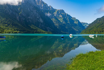 Scenic view of lake and mountains against sky