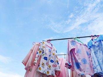 Low angle view of clothes drying on clothesline against sky