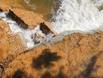 High angle view of waves splashing on shore