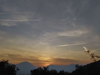 Low angle view of silhouette mountains against sky during sunset