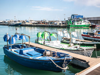 Boats moored at harbor