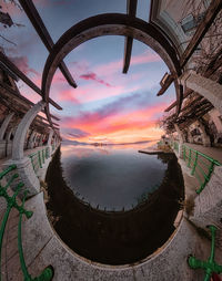 Digital composite image of swimming pool against sky during sunset