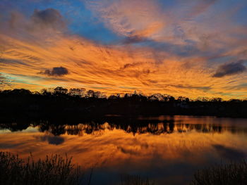 Scenic view of lake against romantic sky at sunset