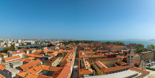 High angle view of townscape against blue sky