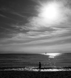 Silhouette person on beach against sky