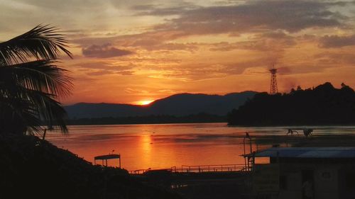 Scenic view of lake against orange sky