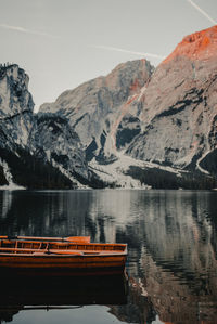 Scenic view of lake by mountains against sky