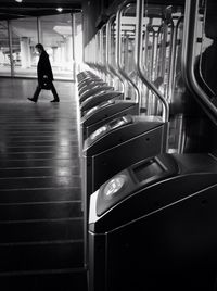 Woman standing on escalator