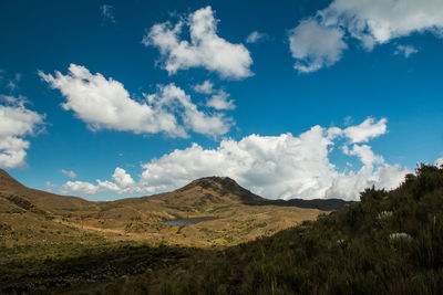 Scenic view of mountains against blue sky